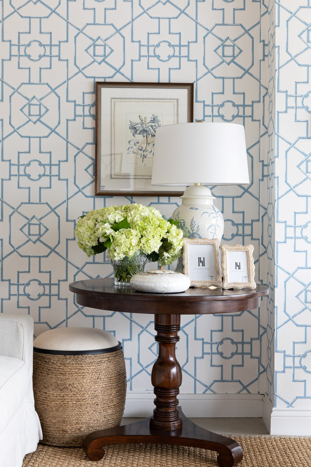 Styled image of Ambrose Centre Table with hydrangeas , photo frames a lamp and box sitting on top