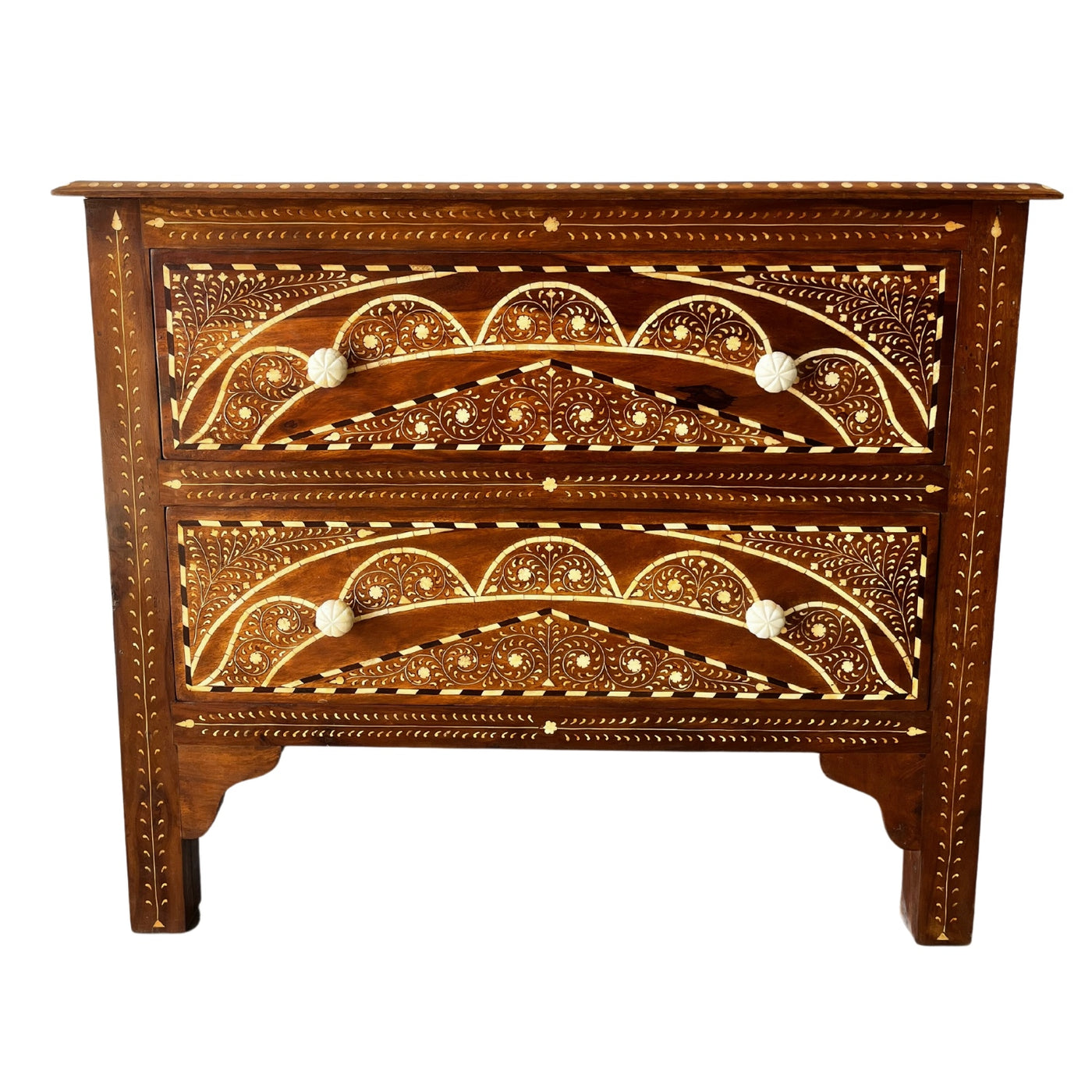 Chest of drawers in tones of chestnut and black with inlay detailing and four bone scalloped knobs