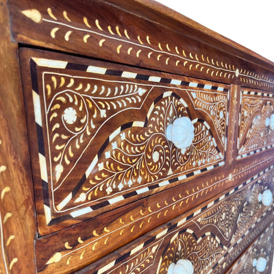 Close up image of bone inlay detailing and scalloped knobs