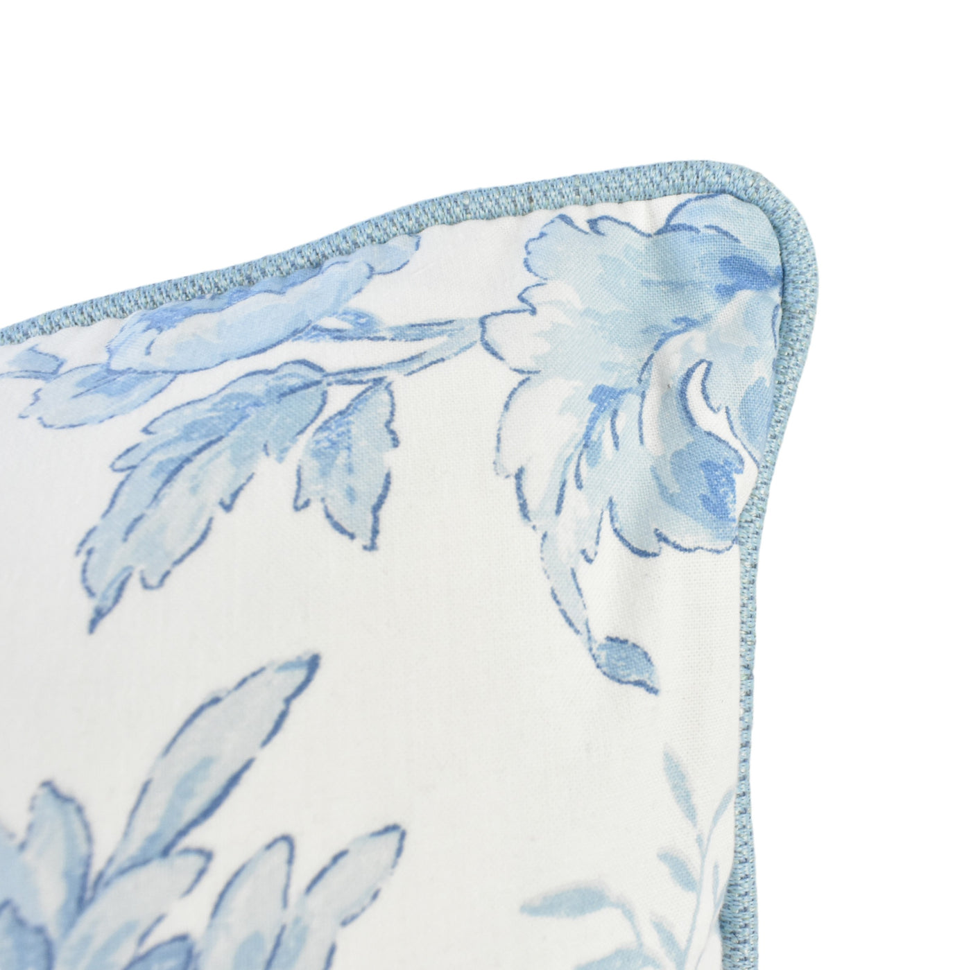 Close up image of alice blue floral cushion with soft blue piping