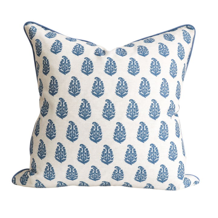 Decorative pillow with blue tree pattern on a white background