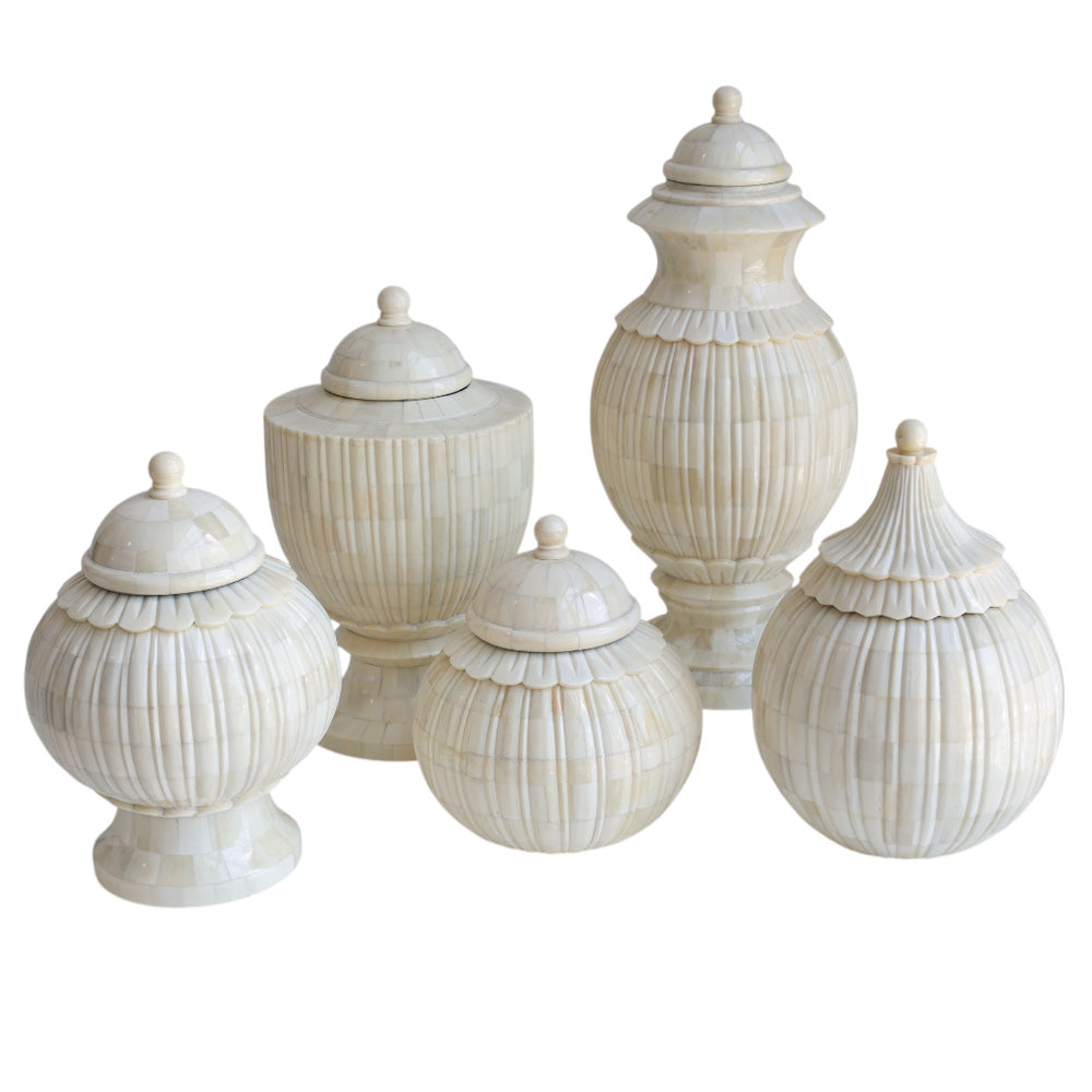 Set of decorative white urns with lids on a white background