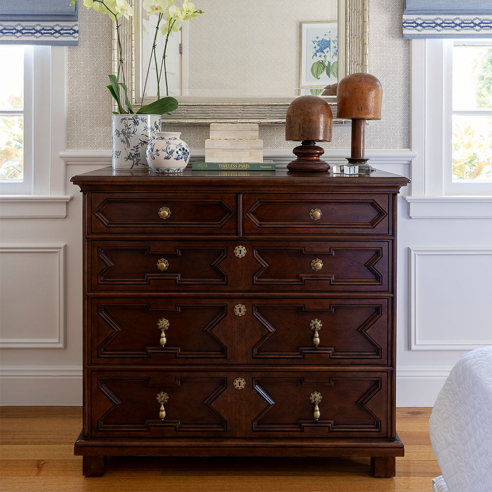 Bordeaux Chest in a bedroom styled with a silver mirror, blue and white pots and two bone boxes on top