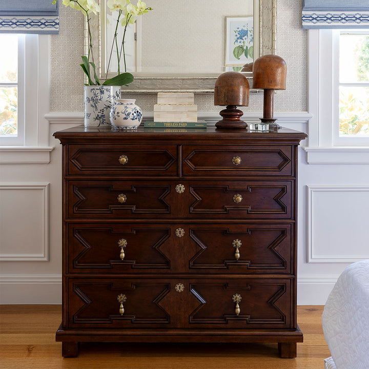Bordeaux Chest in a bedroom styled with a silver mirror, blue and white pots and two bone boxes on top