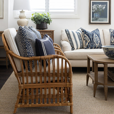 Two cape cod rattan armchairs in a lounge room setting. Styled with Indigo leopard print cushions and navy lumbar cushion. 
