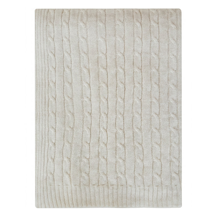 Throw blanket in cream with cable knit pattern on a white background