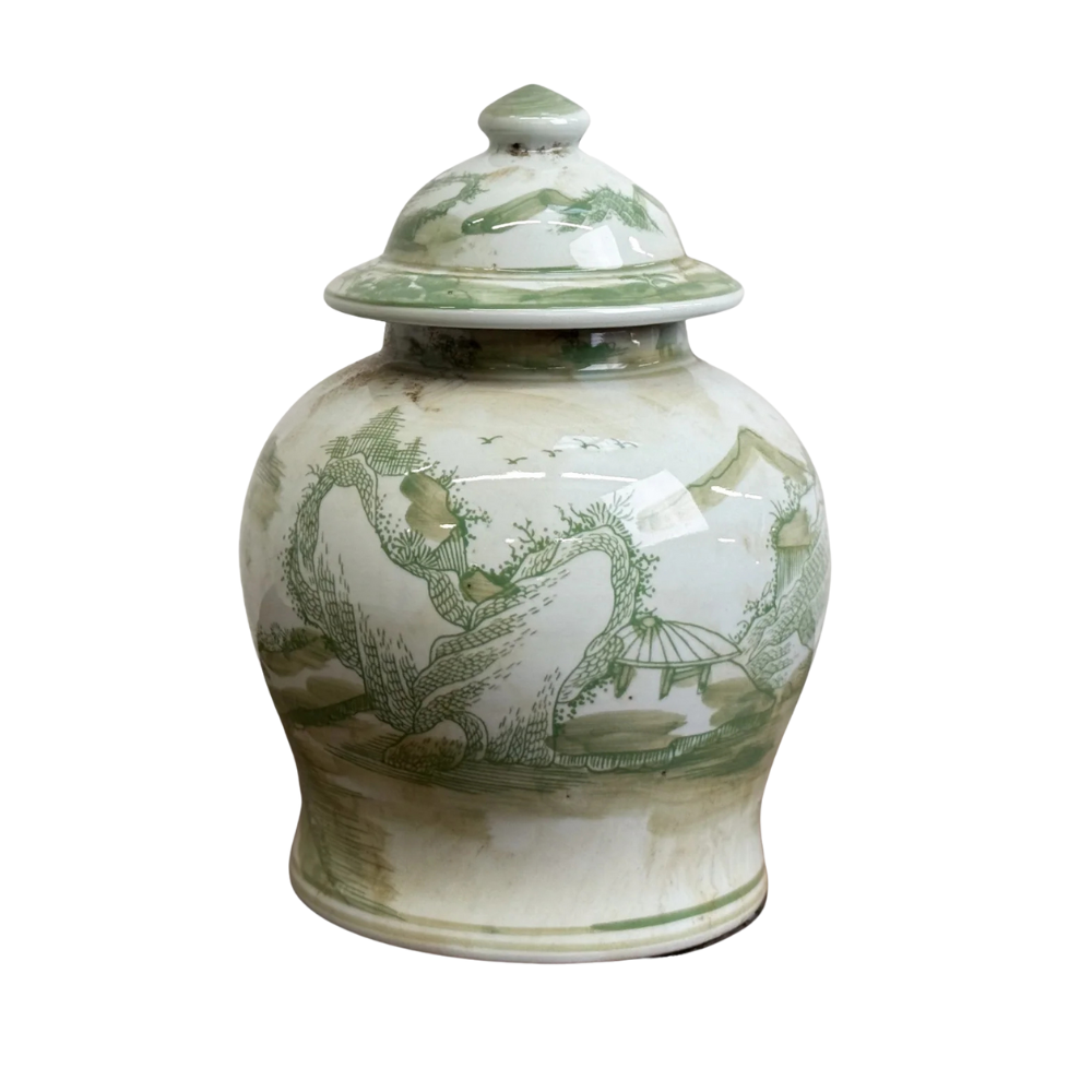 White ceramic jar with green countryscape design on a white background