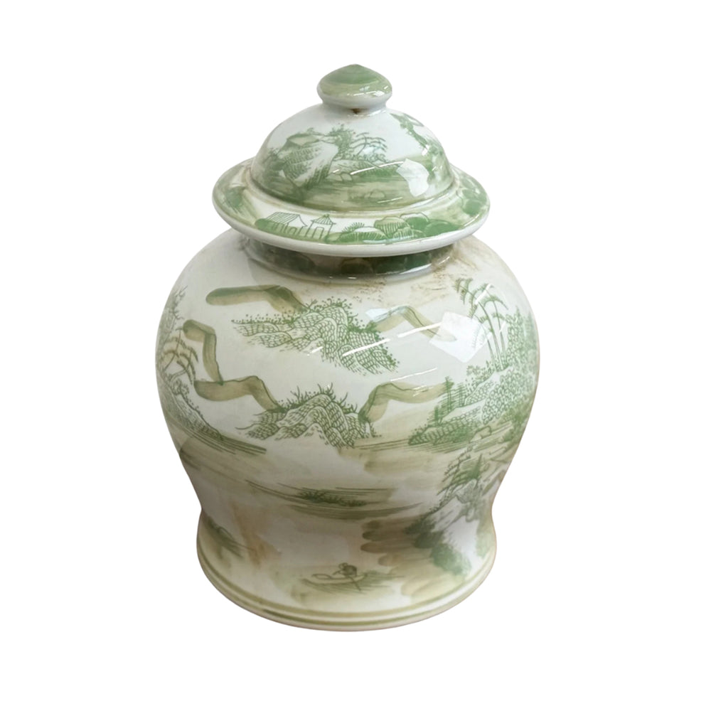 White ceramic jar with green countryscape design on a white background