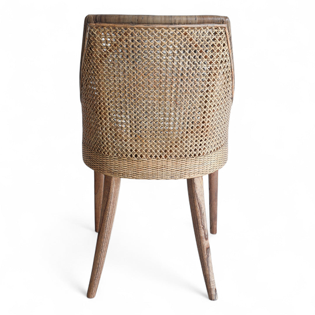 Back of rattan dining chair with mindi timber legs