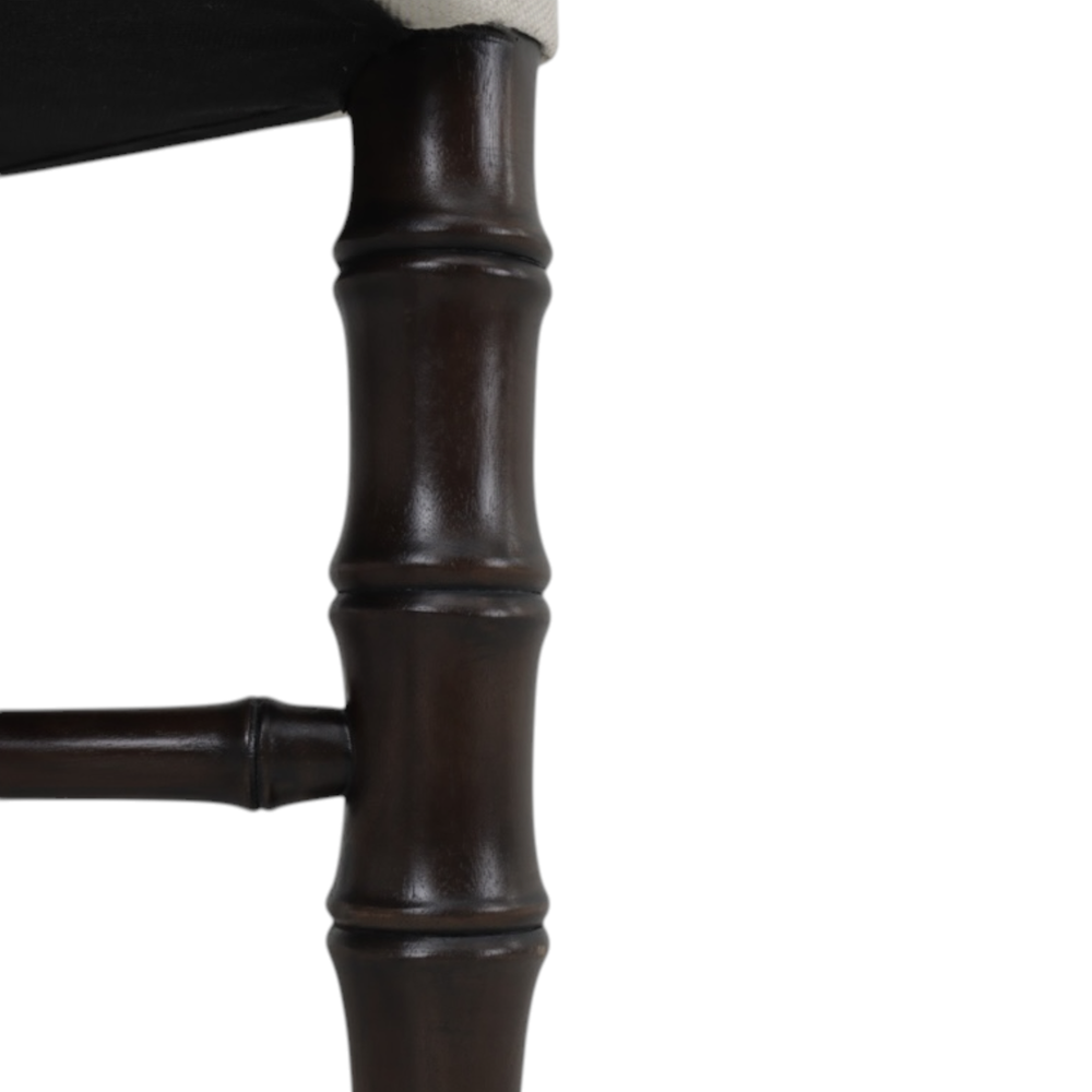 Close-up of a dark brown bamboo-style stool leg on a white background