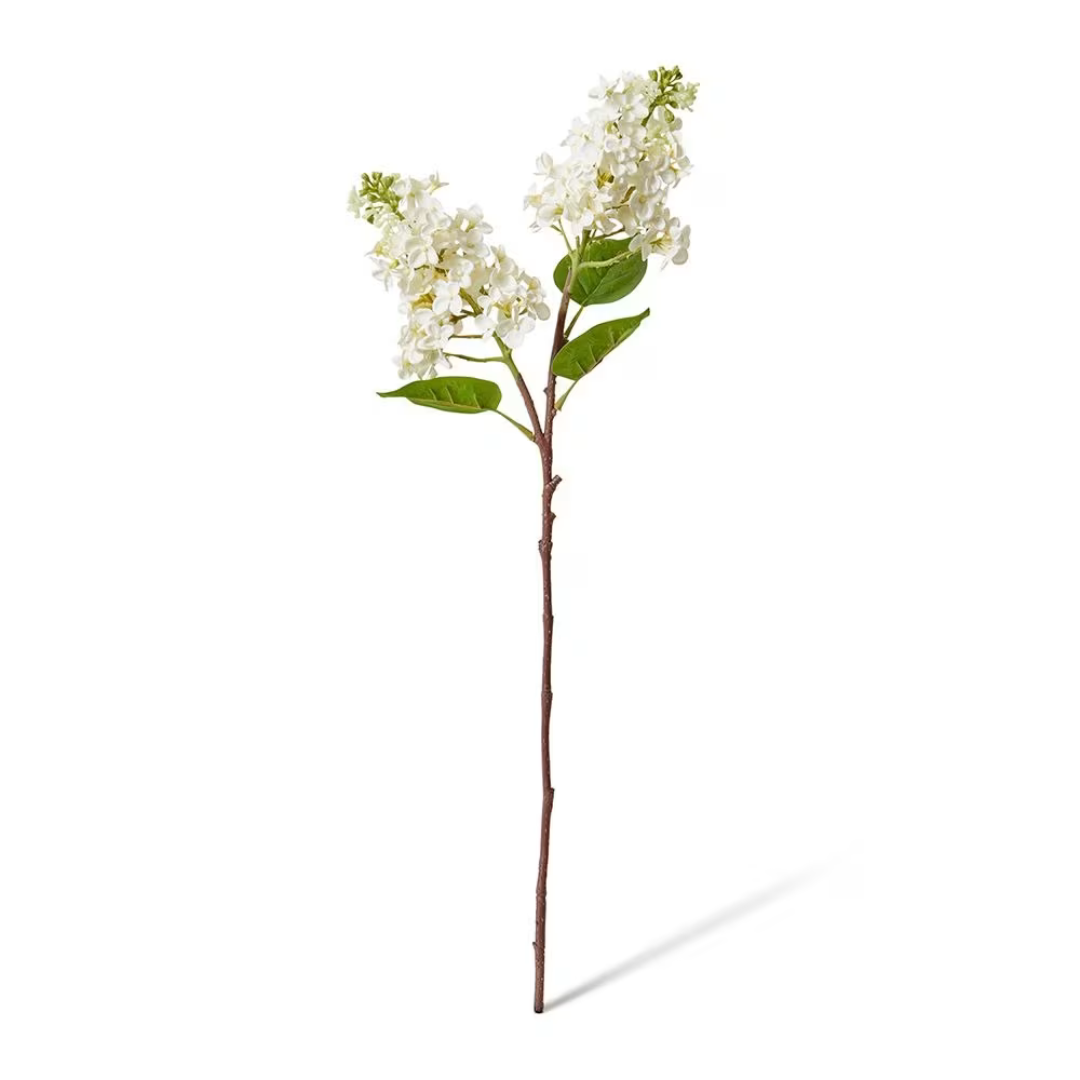 Artificial flower branch with white flowers and green leaves on a white background