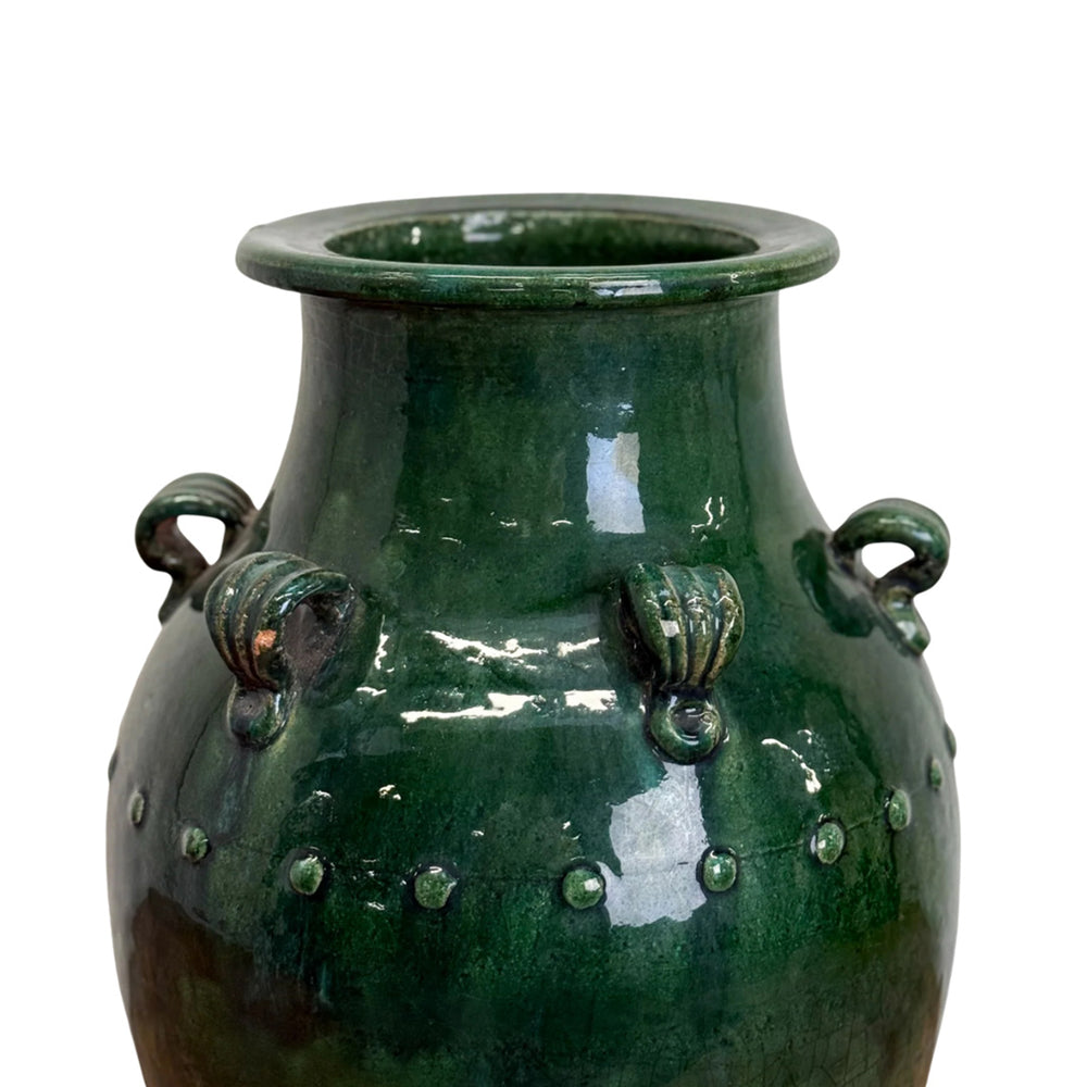 Green ceramic vase with decorative elements on a white background