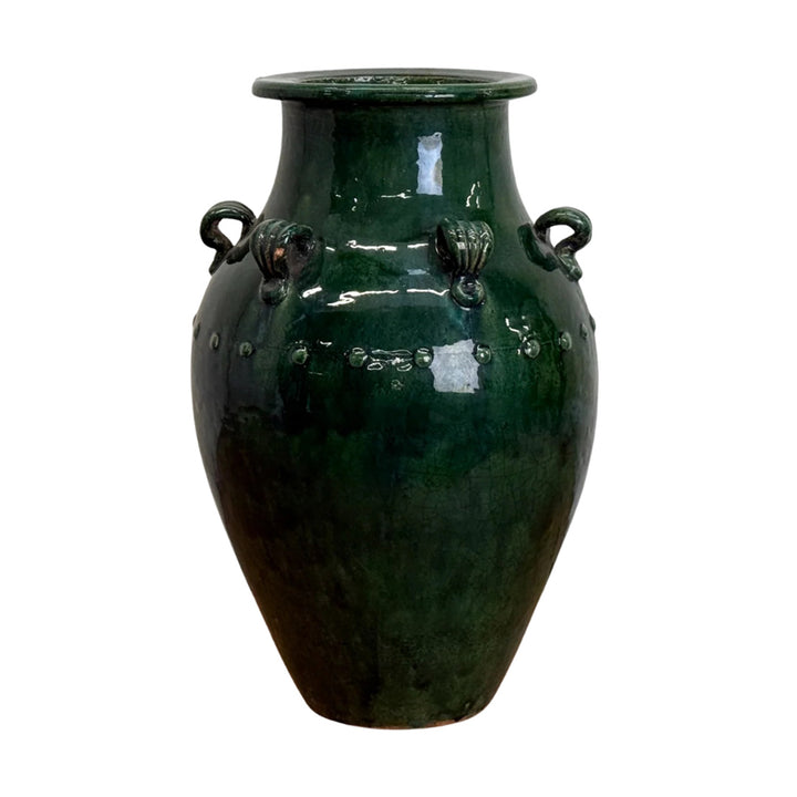 Green ceramic vase with four handles on a white background
