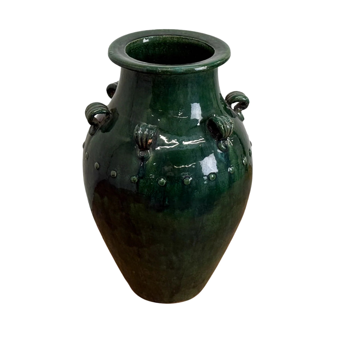 Green ceramic vase with decorative handles on a white background