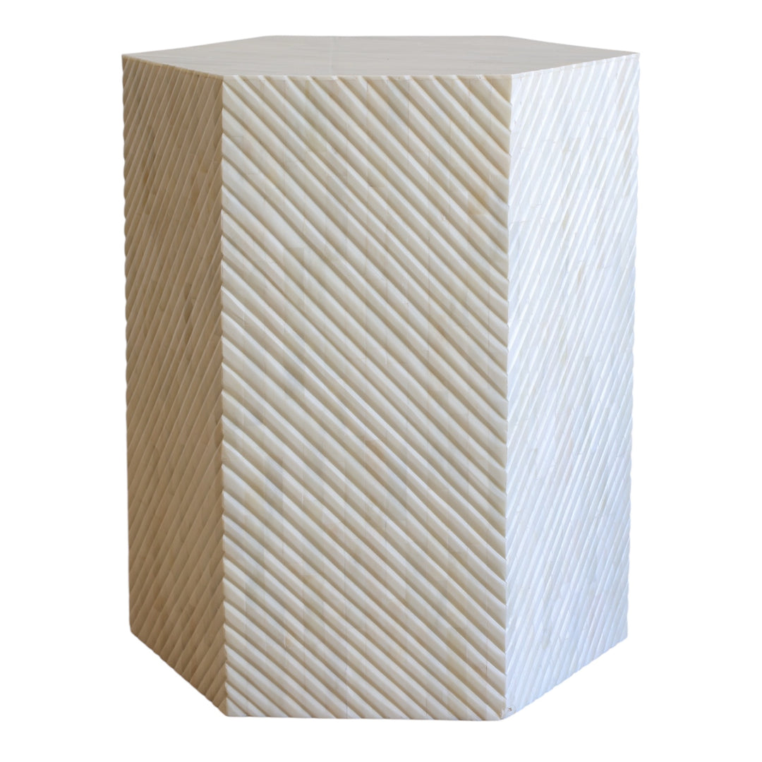 Hexagonal side table with a geometric pattern on a white background
