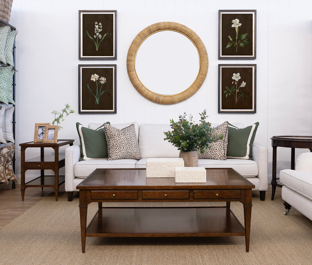 Living room with a white sofa, wooden coffee table, and decorative elements.