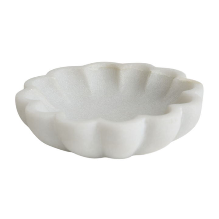 White marble shell-shaped dish on a white background