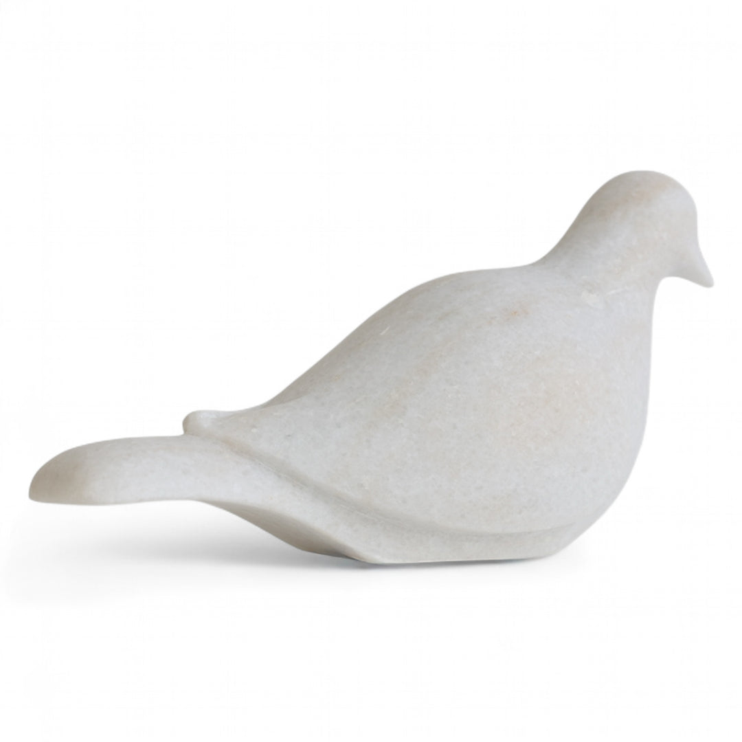 White marble dove sculpture on a white background