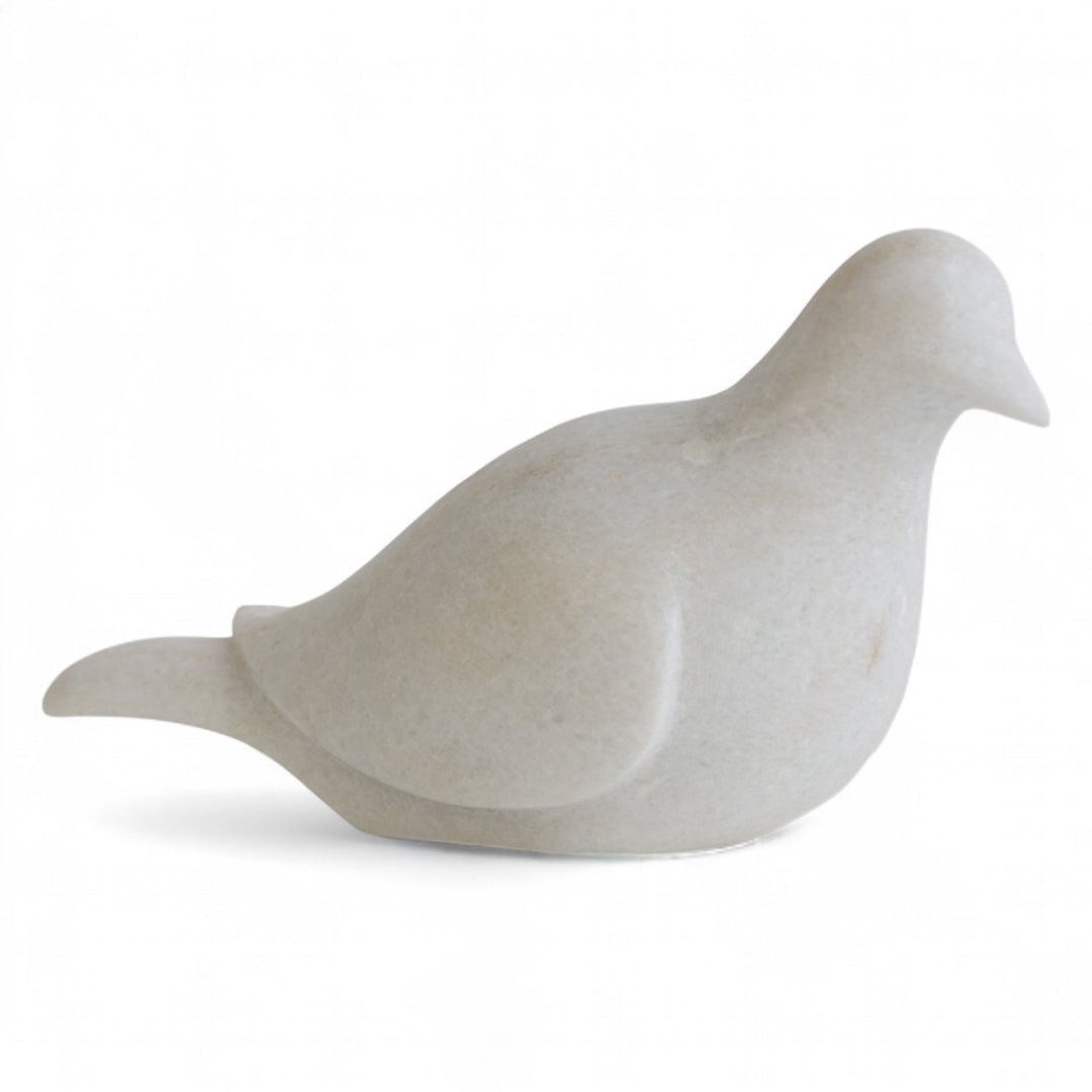 White marble dove sculpture on a white background