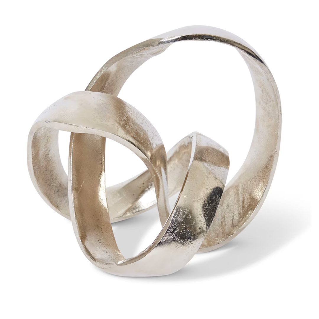 Silver abstract sculpture with intertwined loops on a white background