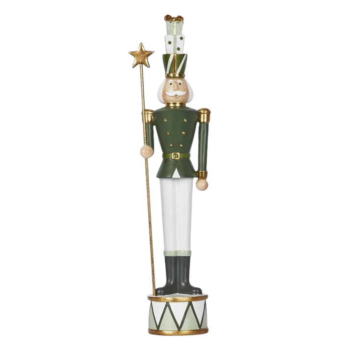 Decorative nutcracker figure holding a star on a white background