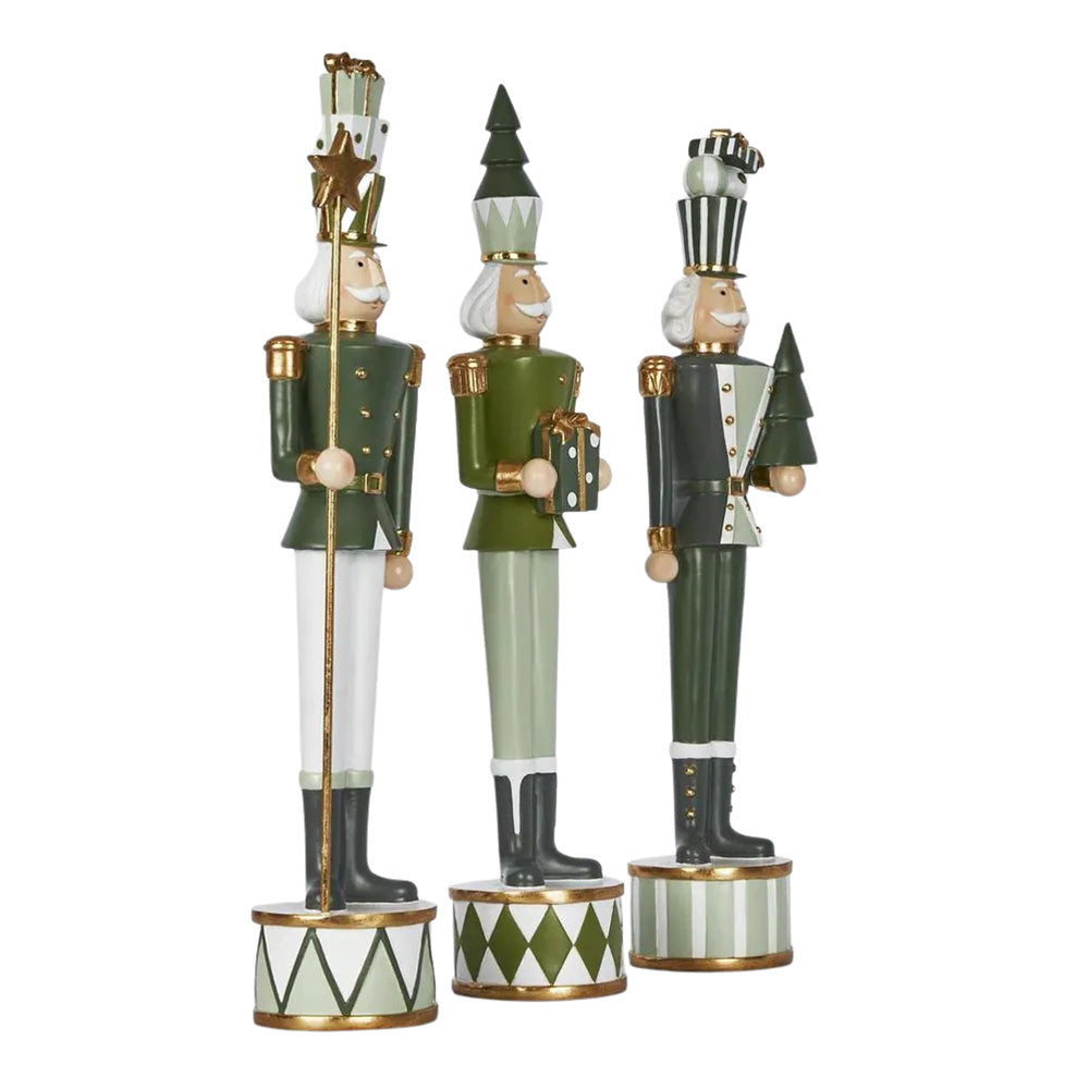 Three decorative nutcracker figurines with green uniforms and gold accents on a white background.