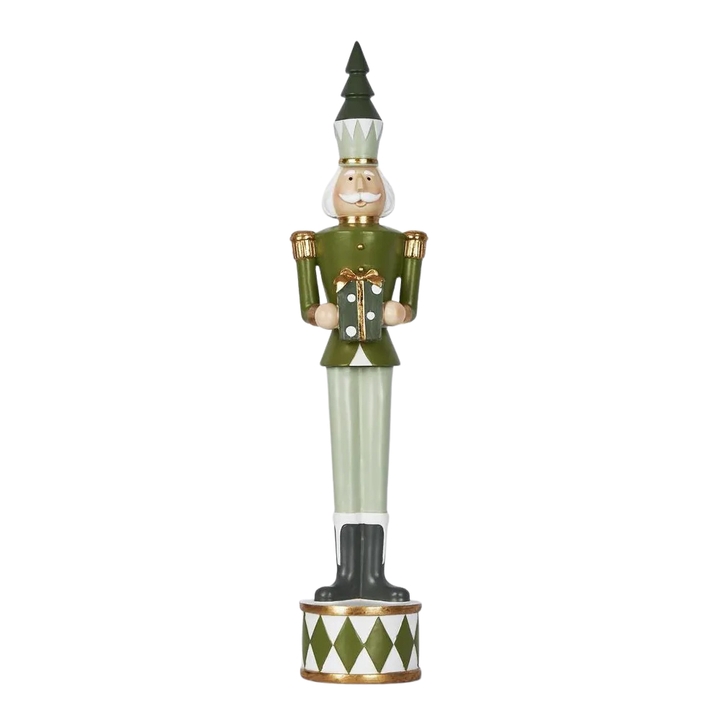 Decorative nutcracker figure with green outfit and hat on a white background