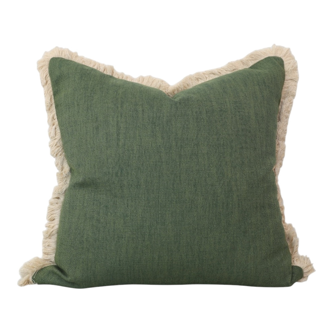 Green pillow with beige fringes on a white background