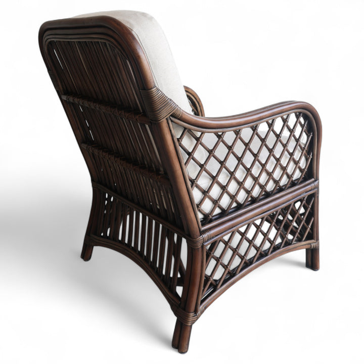 Wicker armchair with a white cushion on a white background