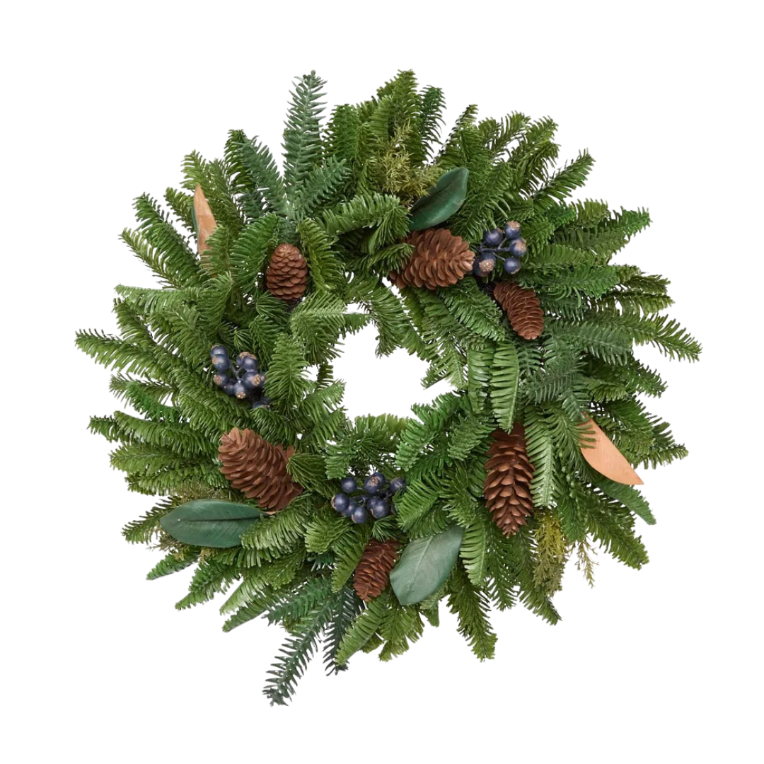 Green wreath with pinecones and berries on a white background