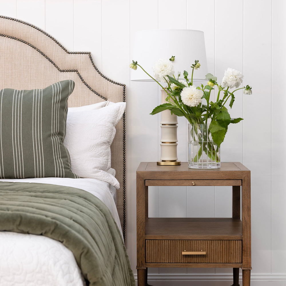 Bedroom with a bed, nightstand, and decorative elements