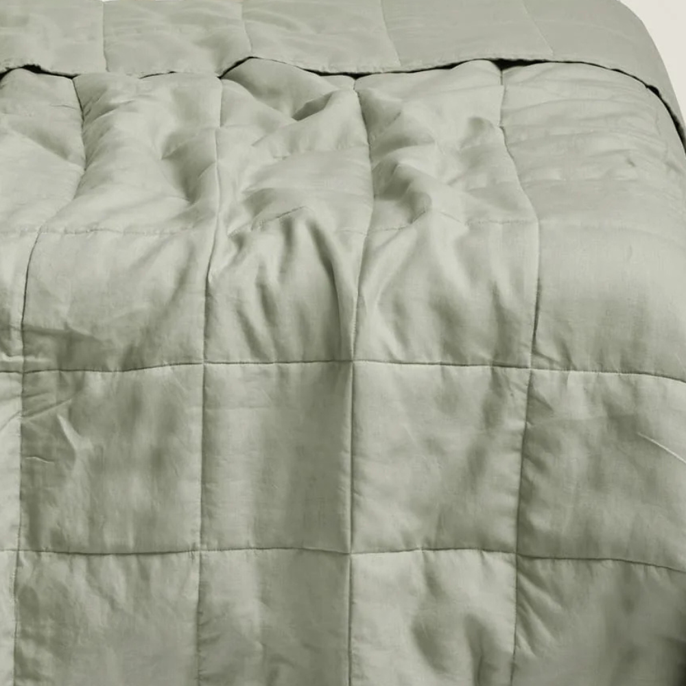 Close-up of a soft sage quilted comforter