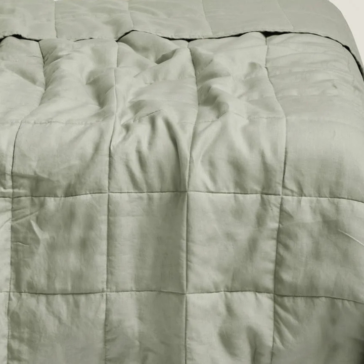Close-up of a soft sage quilted comforter