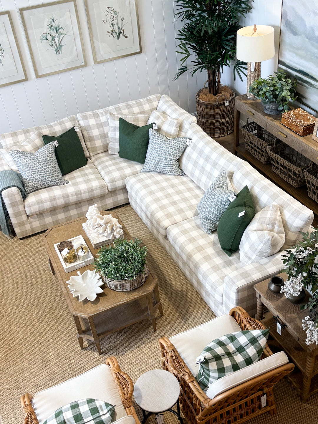 Cozy living room with a plaid sofa, wicker chairs, and decorative elements.